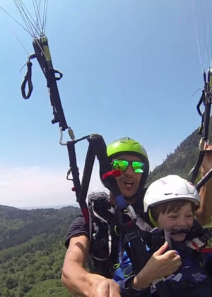 children paragliding flight